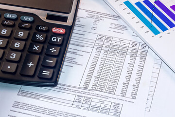 The calculator lies on accounts and reports. Workplace of an accountant.