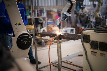 Robotics engineer fitting sensors to traditional engineering lathe in robotics research facility