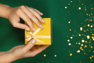 Gift of gold color on a green background.