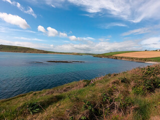 Celtic Sea Bay near Clonakilty, Ireland. Beautiful seascape. Blue sky with white clouds. Coastal nature.