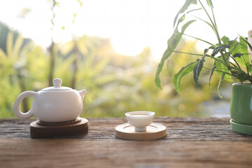 Fototapeta na wymiar Tea cup and tea pot on wooden table