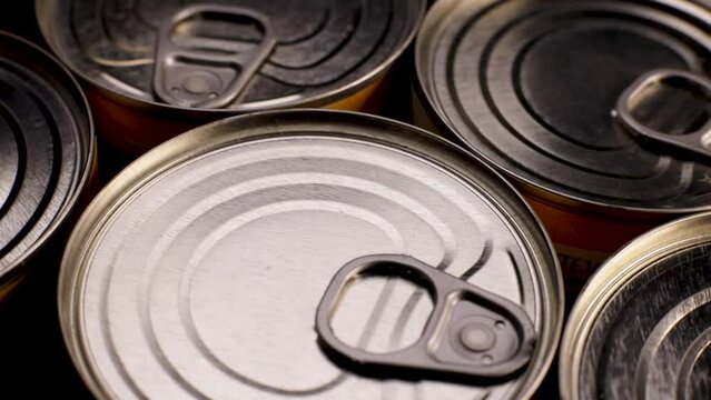 Metal food cans spinning. Tourist food, military and humanitarian aid