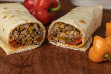 Close up of Burritos, typical Mexican food, with beef, vegetables and spices.