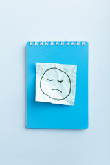 sad face on blue sticker