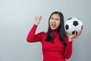 Asian attractive woman soccer sports fans in red sweater isolated over background.