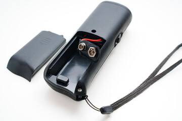 Ultrasonic dog repeller open without batteries on a white background. 