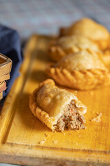 Close up of fried Argentine empanada cut in the middle.