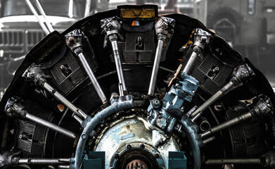 The engine of a piston airplane. Part of the mechanism on a blurred background. Selective focus.