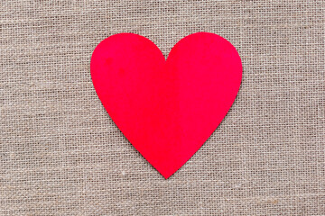 Paper craft heart on a burlap background. Valentine flat lay with red heart.