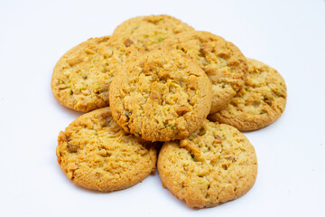 Pistachio and almond cookies on white background.