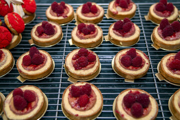 Rows of strawberry tartlets in the bakery counter