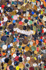 Large collection of colorful plastic buttons in pile for sewing