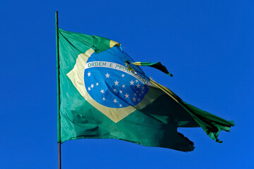 Brazilian flag torn in strong wind