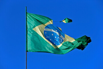 Brazilian flag torn in strong wind