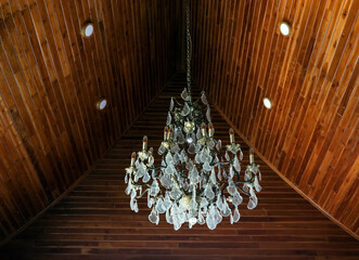 Chandeliers hanging on the vintage wooden roof wall.