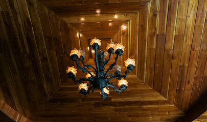 Chandeliers hanging on the vintage wooden roof wall.
