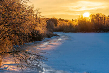 Sunset over the frozen river. Österbotten/Pohjanmaa, Finland.