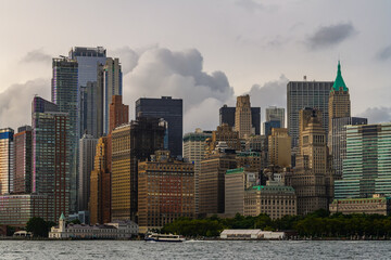 The financial district in lower Manhattan in New York City with clouds in background.