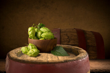 mug of beer, wheat ears, hops and beer barrel on a wooden background. High quality photo