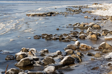 Frozen stones on the river bank