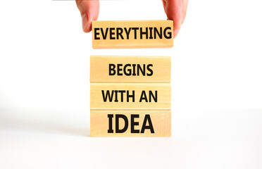 Everything begins with an idea symbol. Concept word Everything begins with an idea on wooden blocks. Beautiful white table white background. Business everything begins with an idea concept. Copy space