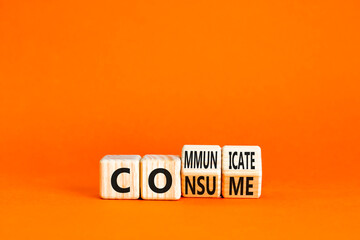 Consume or communicate symbol. Concept word Consume or Communicate on wooden cubes. Beautiful orange table orange background. Business consume communicate concept. Copy space.
