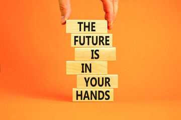 The future is in your hands symbol. Concept words The future is in your hands on wooden blocks on a beautiful orange table orange background. Businessman hand. Business future in your hands concept.