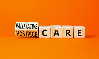 Palliative or hospice care symbol. Concept word Palliative care Hospice care on wooden cubes. Beautiful orange table orange background. Medical palliative or hospice care concept. Copy space.