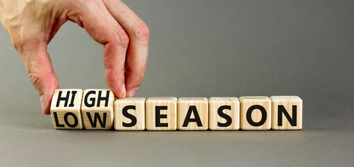 High or low season symbol. Concept words High season and Low season on wooden cubes. Businessman...