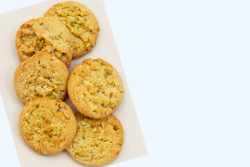 Pistachio and almond cookies on white background.