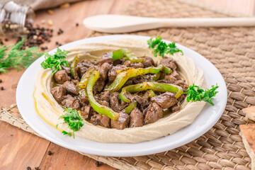 Liver Hummus served in dish isolated on table side view of arabic food