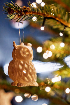 Christmas tree decorated with garlands and owl baubles