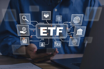 ETF,Exchange traded fund.Businessmen using a smartphone with icons of ETF and trading.Business finance concept.Stock market index fund.