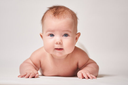 portrait of a four-month-old baby on a white background
