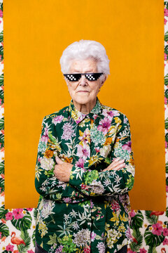 Confident elderly female in pixel sunglasses