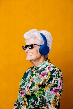 Stylish senior woman listening to music