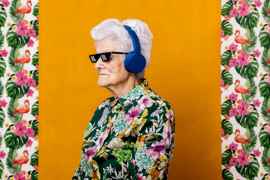 Stylish senior woman listening to music