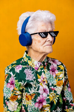 Stylish senior woman listening to music