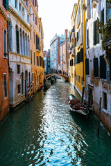 Venice, its characteristic architecture. View of an internal canal, with the docking of boats and gondolas.