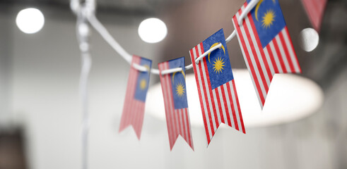 A garland of Malaysia national flags on an abstract blurred background