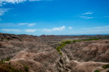 The rugged mountains of the Badlands. These geologic deposits contain one of the world’s richest fossil beds. Ancient mammals such as the rhino, horse, and saber-toothed cat once roamed here