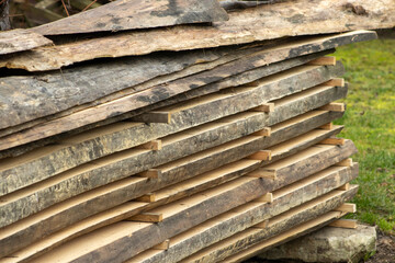 Piled lumber near a lumber mill. Lumber and wood slice. Stacked lumber. Folded wood.Closeup wood board