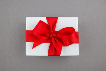 Gift box with a ribbon on the cheese. Close-up.