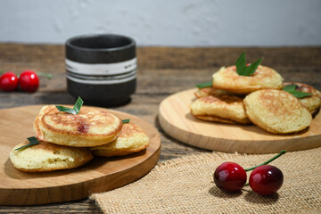 Kue Khamir or samir or Khamir cake on wooden plate. Khamir cake is a traditional snack from Pemalang, Indonesia. This cake is made from flour, butter and egg dough. Selective Focus