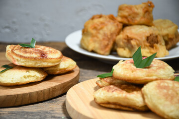 Kue Khamir or samir or Khamir cake on wooden plate. Khamir cake is a traditional snack from Pemalang, Indonesia. This cake is made from flour, butter and egg dough. Selective Focus