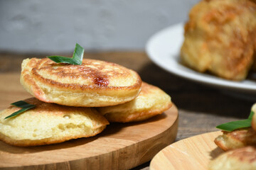Kue Khamir or samir or Khamir cake on wooden plate. Khamir cake is a traditional snack from Pemalang, Indonesia. This cake is made from flour, butter and egg dough. Selective Focus