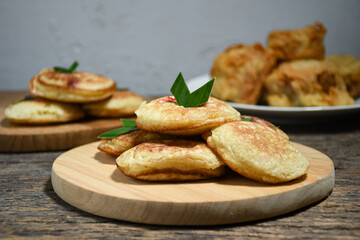 Kue Khamir or samir or Khamir cake on wooden plate. Khamir cake is a traditional snack from Pemalang, Indonesia. This cake is made from flour, butter and egg dough. Selective Focus