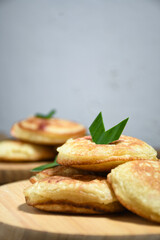Kue Khamir or samir or Khamir cake on wooden plate. Khamir cake is a traditional snack from Pemalang, Indonesia. This cake is made from flour, butter and egg dough. Selective Focus
