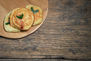 Kue Khamir or samir or Khamir cake on wooden plate. Khamir cake is a traditional snack from Pemalang, Indonesia. This cake is made from flour, butter and egg dough. Selective Focus