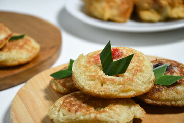 Kue Khamir or samir or Khamir cake on wooden plate. Khamir cake is a traditional snack from Pemalang, Indonesia. This cake is made from flour, butter and egg dough. Selective Focus
